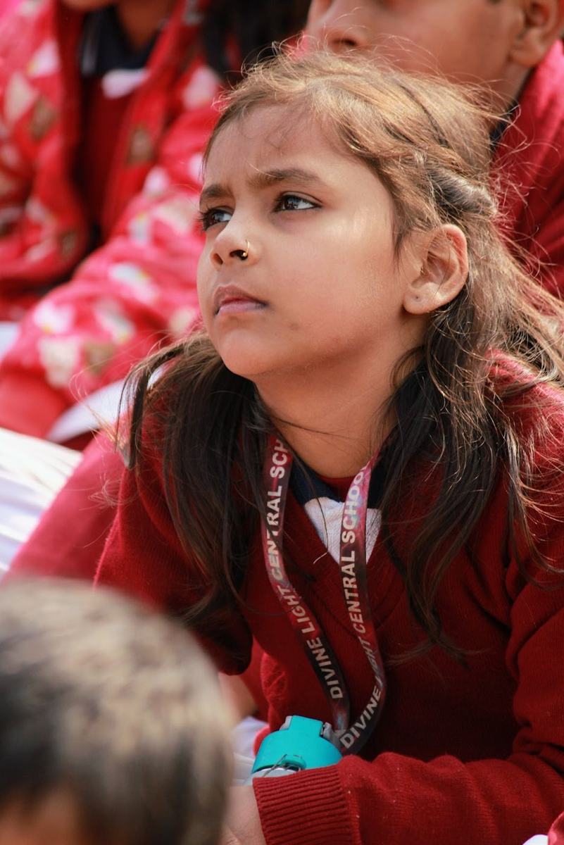 A student listening attentively during an outdoor session