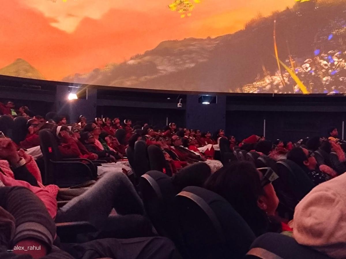 Students watching a dome show at a planetarium